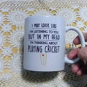 Humorous coffee cup, thinking of playing cricket